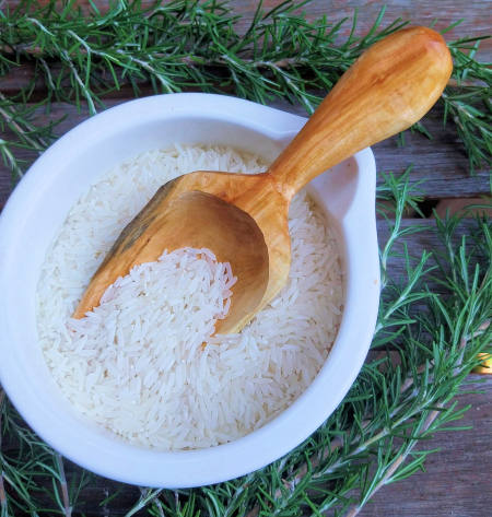 Handcrafted wooden scoop in rice